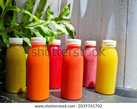 Cold pressed juice in a plastic bottle. Royalty-Free Stock Photo #2039765702