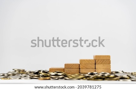 Coins scattered on wooden stairs. Financial concept. Savings Concepts, Stock market concept. Investment concept