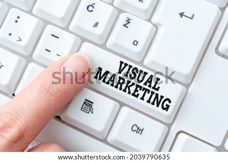 Hand writing sign Visual Marketing. Business overview telling the story of your brand or product by creation Lady finger showing-pressing keyboard keys-buttons for update
