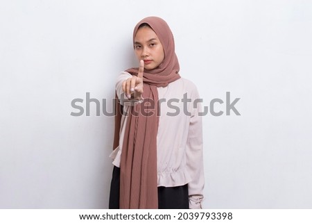 beautiful young muslim woman with open hand doing stop sign with serious expression defense gesture isolated on white background
