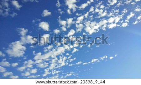 White clouds in the blue sky on a clear day background