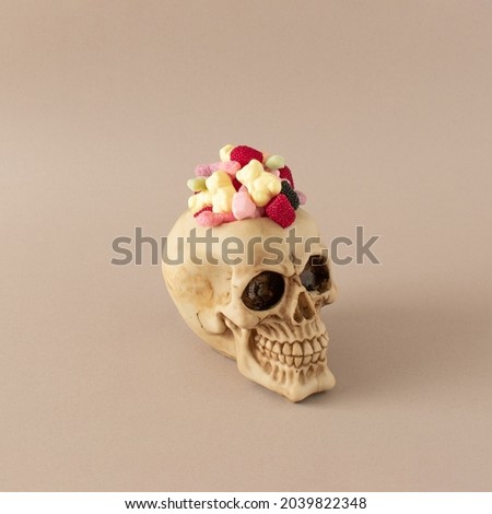 Creepy skull with candies.Minimal scary halloween concept.