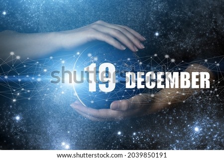 December 19th. Day 19 of month, Calendar date. Human holding in hands earth globe planet with calendar day. Elements of this image furnished by NASA. Winter month, day of the year concept