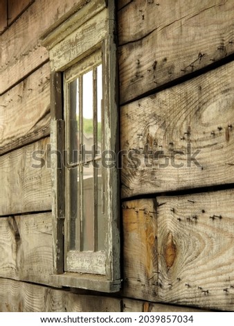 
wooden window with peeling paint and exposed nails