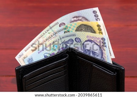 Romanian money - leu in the black wallet Royalty-Free Stock Photo #2039865611