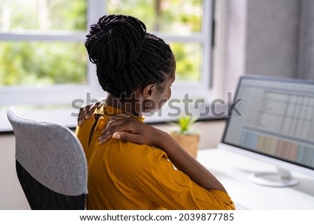 Ergonomic Chair And Posture Behind Workstation Computer. Shoulder Pain Royalty-Free Stock Photo #2039877785