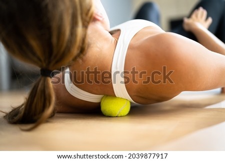 Back Trigger Point Massage Using Tennis Ball Myofascial Release Royalty-Free Stock Photo #2039877917