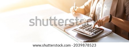 Accountant Lady In Office Using Calculator For Customs Accounting