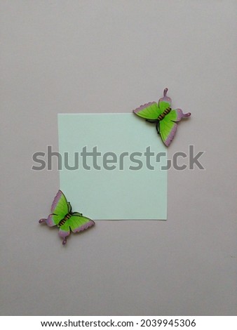 Two butterflies on lilac backgrounds with copy space.