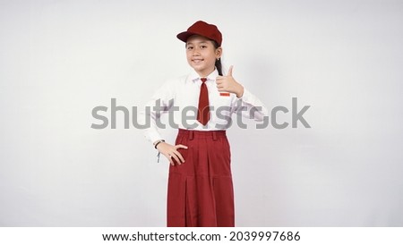 Smiling and okay asian elementary school girl isolated on white background