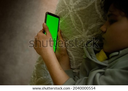 teenager girl holding phone with green screen, adolescent girl using phone, modern digital technologies