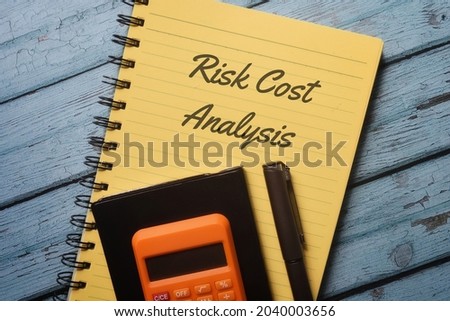 Top view of book with Risk Cost Analysis. Business concept