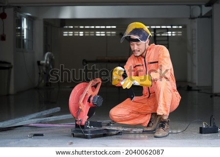Industrial worker inspect cut steel to the size required by customer. For the real estate project received. Metal grinding on steel spare part in workshop. Royalty-Free Stock Photo #2040062087