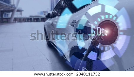 Hybrid electric car charging power battery using pump cable with visual graphic double exposure banner copyspace blue city bokeh background modern futuristic concept. Innovative eco energy resources. 