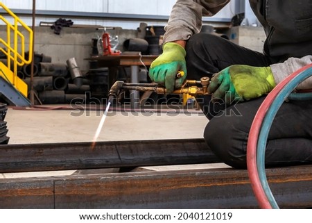 Welding, or gas welding in the U.S. and oxy-fuel cutting are processes that use fuel gases and oxygen to weld and cut metals, respectively. Royalty-Free Stock Photo #2040121019