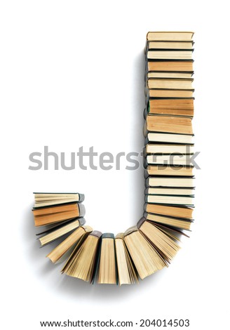 Letter J formed from the page ends of closed vintage hardcover books standing on a white background from a set or series of numbers