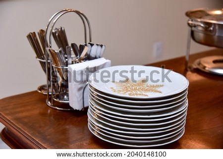 plates stacked on wooden table
