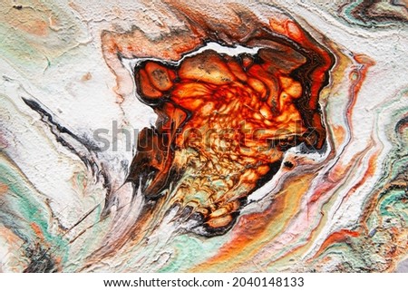 Texture in the style of lava fluid art. Abstract background with paint mixing effect. Liquid acrylic paint background. Black, orange and white colors.