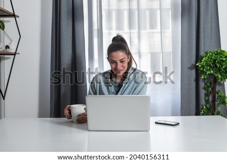 Young woman a psychotherapist doctor having online psychotherapy therapy with her patient and talk via video call on the laptop computer while she working at home in the home office Royalty-Free Stock Photo #2040156311