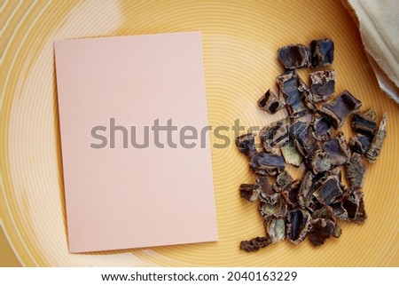 Carob - coffee alternative - organic product on the plate. Natural plant-based caffeine antioxidants. Mock up of business card. High quality photo