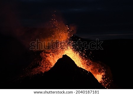 Eruption at Fagradalsfjall, Iceland. Red and orange incandescent lava is erupted from the volcanic vent. Taken at night, the lava is isolated on a black background. Royalty-Free Stock Photo #2040187181