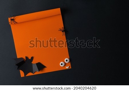 Mock up for Halloween with orange poster on black background and decorative elements, text copying, flat layout