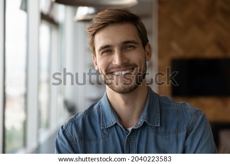 Profile picture of smiling successful young Caucasian businessman or boos look at camera pose in office. Headshot portrait of happy millennial male employee at workplace. Employment, hr concept. Royalty-Free Stock Photo #2040223583