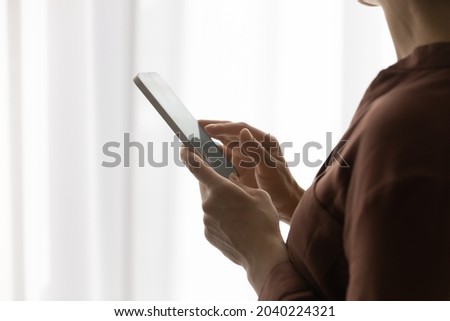 Using online app. Close up of young woman user of modern smartphone gadget. Happy gen z female browse internet on phone type message in dating chat dial number swipe quick menu on screen. Copy space Royalty-Free Stock Photo #2040224321