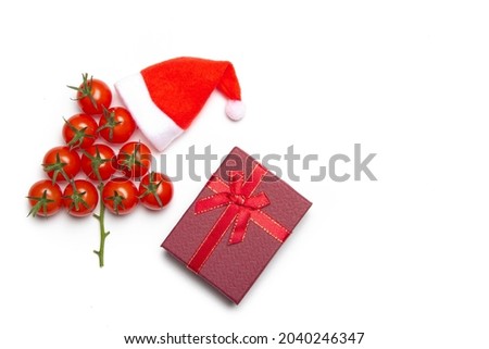 Christmas tree made of cherry tomatoes on a white background. Isolated background. Christmas decoration. Food tree. New year and Christmas. Seasonal holiday. Decoration of new year's window displays. 