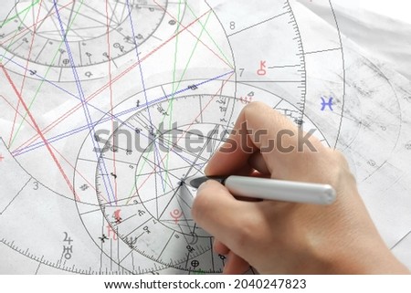 Astrology. Astrologer calculates a natal chart and makes a forecast of fate. Astrological forecast, mysticism, science. Astrological background. Royalty-Free Stock Photo #2040247823