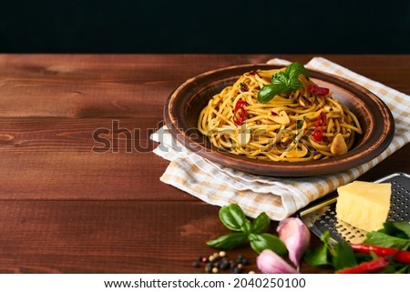 spaghetti pasta aglio e olio with chili flakes parsley garlic on Royalty-Free Stock Photo #2040250100