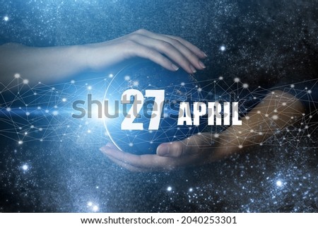 April 27th. Day 27 of month, Calendar date. Human holding in hands earth globe planet with calendar day. Elements of this image furnished by NASA. Spring month, day of the year concept