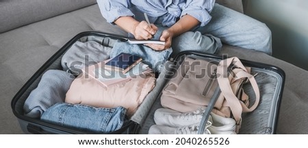 Travel. Online travel plans with Covid passport and Covid test. Traveling after quarantine, lockdown, covid 19. Staycation.local travel new normal.Girl packs baggage in suitcase and travel documents Royalty-Free Stock Photo #2040265526