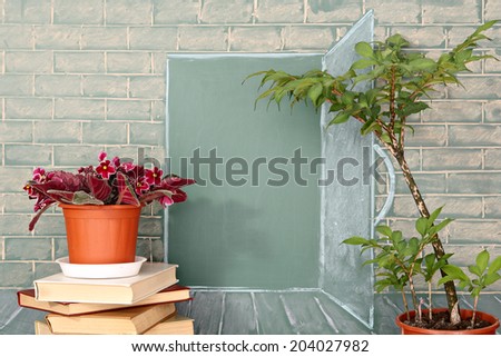 Flowers and tree before illustration on a chalkboard of the open door in class
