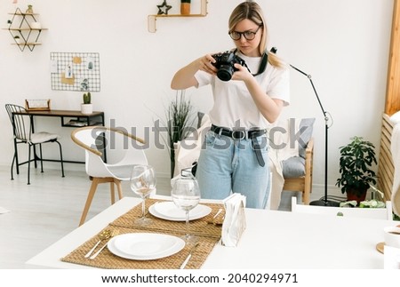 a girl takes pictures with a camera