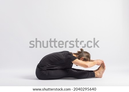 Seated pincer pose. Yoga Posture (Asana) Royalty-Free Stock Photo #2040295640
