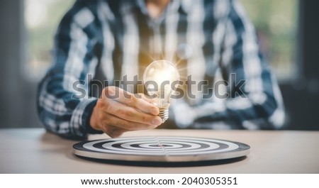 thinking and creative concept, Close up the light bulb and working on the desk, Creativity, novation are keys to success,  new idea and innovation with Brain and light bulbs, target dart board concept