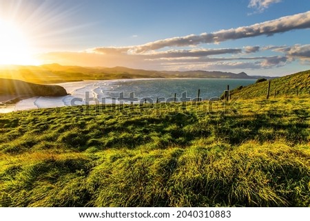 Magnificent summer sunset on the Pacific Ocean. The majestic beauty of the New Zealand. South island. Caitlins Scenic Road. The concept of ecological and photo tourism