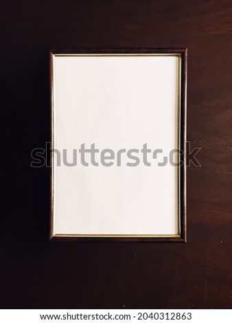 Blank picture frame on wooden background, luxury home decor and interior design, poster print and printable art mockup. Royalty-Free Stock Photo #2040312863