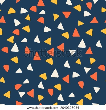 cute simple seamless pattern. hand-drawn beige, orange, coral triangles are randomly arranged on a dark blue background. vector