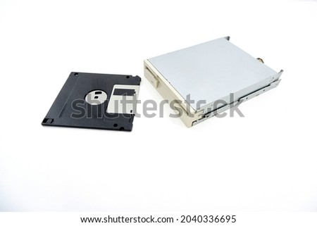 Internal Drive for FDD 3.5-inch floppy disks for PC, White with a black 1.44 MB floppy disk, for flexible magnetic disks, isolated on a white background. Internal Floppy Disk Drive