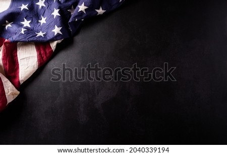 Happy Veterans Day concept. Vintage american flags against black  stone  background. November 11.
