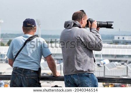 Photographers taking pictures of the aircrafts at Munich airport.