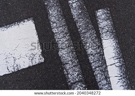 A faint pattern of traffic signs drawn on the road