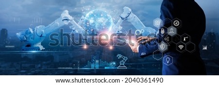 Manager engineer check and control automation robot arms machine on global network and monitoring software. Innovation of robotics and digital manufacturing operation on futuristic and industry 4.0. Royalty-Free Stock Photo #2040361490