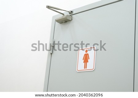 Toilet sign on the toilet door. Women WC signs for toilet. Women's bathroom on a white wall