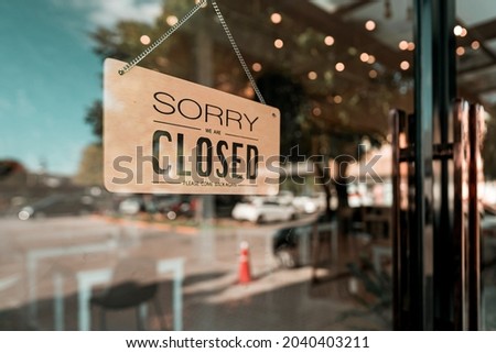 Close cafe or restaurant. Close sign board on glass door in modern cafe coffee shop