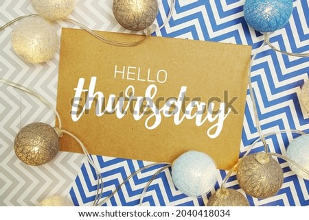 Hello Thursday typography text on paper card with LED cotton balls decoration
