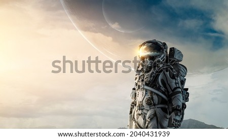Astronaut walking on an unexplored planet. Mixed media Royalty-Free Stock Photo #2040431939