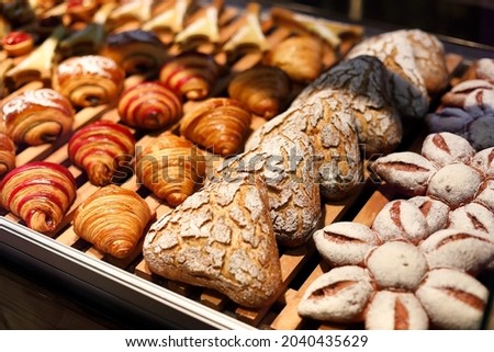 Sweet pastries on the shelf in a supermarket. Selective focus.